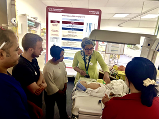 Group of people watch a demonstration