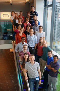 Group of people standing on stairs smiling
